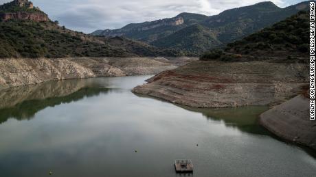 A &quot;bathtub ring&quot; of dirt is seen around the edge of the Siurana reservoir in Catalonia, Spain, in November 2022.