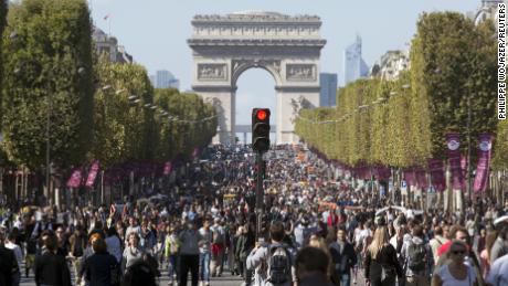 People walk on the Champs-Elysees during a car-free day central Paris.