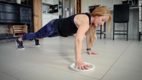 From a plank position, use the plate to make circles on the floor while keeping a strong core and neutral spine.