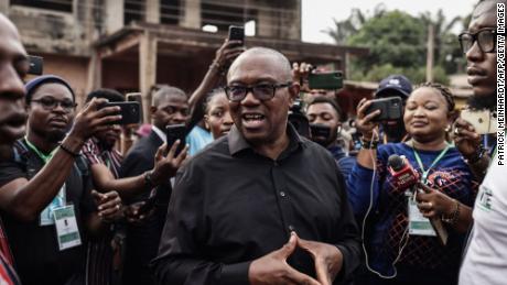 Labour Party presidential candidate Peter Obi (C) talks to the media at outside a polling station in Amatutu on Saturday, before polls opened.