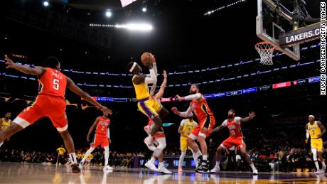 Dennis Schröder of the Los Angeles Lakers shoots over Jonas Valančiūnas of the New Orleans Pelicans.