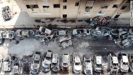 An aerial view shows a building and cars burnt in an attack by Israeli settlers, near Huwara in the West Bank, on February 27, 2023.