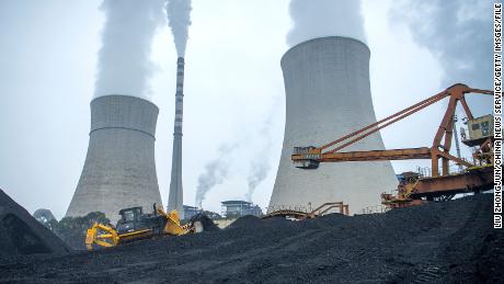 A bulldozer pushes coal onto a conveyor belt at the Jiangyou Power Station on January 28, 2022 in China&#39;s Sichuan province. 