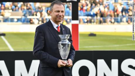 Former Canada Soccer President Nick Bontis holding up the George Gross Memorial Trophy.