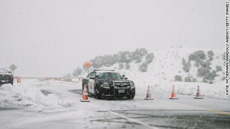 Highway Patrol blocks Highway 39 due to blizzard conditions during a rare snowstorm Saturday in Los Angeles County.