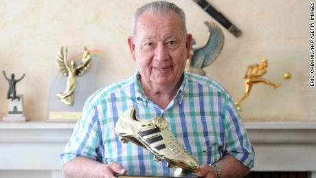 Just Fontaine poses with a trophy for the 1958 football World Cup top-scorer award.