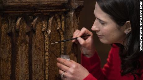 Conservator Krista Blessley works on the Coronation Chair at Westminster Abbey.