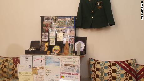 Medals, shields and certificates from Raza&#39;s sporting career are displayed in her family home.