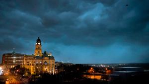 Debris flies through the air as howling winds accompanied by a line of storms approach the old Tarrant County Courthouse in downtown Fort Worth, Texas, on March 2, 2023. (Tom Fox/The Dallas Morning News via AP)