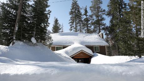 A home is seen buried in snow on Friday in Twin Bridges, California.