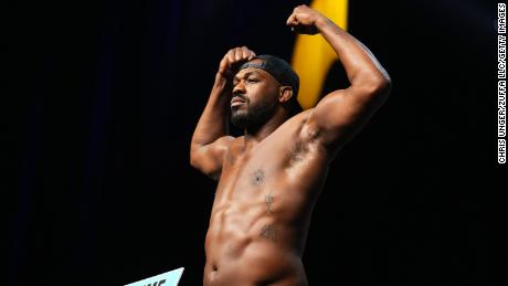 Jon Jones poses on the scale during the UFC 285 ceremonial weigh-in at MGM Grand Garden Arena.