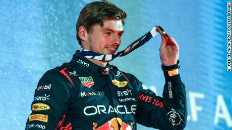 Red Bull Racing&#39;s Dutch driver Max Verstappen holds up his medal on the podium after winning the Bahrain Formula One Grand Prix at the Bahrain International Circuit in Sakhir on March 5, 2023. 