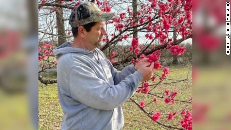 Rusty Mangrum checks on his Red Barron peach trees that are already blooming due to the recent warm temperatures. 