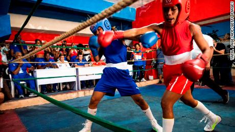 Cuban boxers fight during the first official women&#39;s boxing program in Cuba at the Giraldo Cordova boxing school in Havana, on December 17, 2022. - With a strong right jab to the face of his opponent, Elianni García Polledo (50kg), decided this Saturday the first official women&#39;s boxing match in Cuba, a day awaited for decades by the women of the island. (Photo by YAMIL LAGE / AFP) (Photo by YAMIL LAGE/AFP via Getty Images)