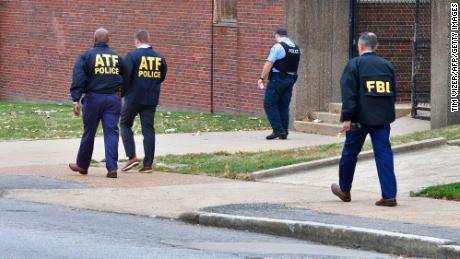 Alcohol, Tobacco, &amp; Firearms agents alongside an FBI agent and a St. Louis metropolitan police officer.