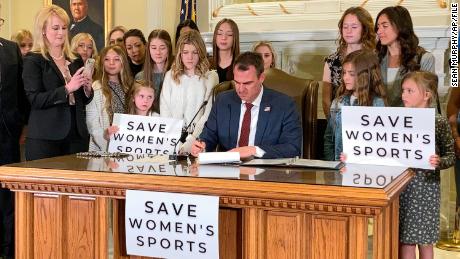 Oklahoma Gov. Kevin Stitt signs a bill on March 30, 2022, that prevents transgender girls and women from competing on female sports teams.