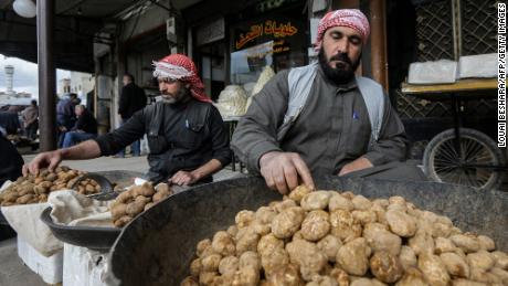 A merchant sorts through desert truffles at a stall in a market in the city of Hama in west-central Syria on Monday. Between February and April, hundreds of impoverished Syrians search for &quot;yellow gold&quot; in Syria&#39;s vast Badia desert -- a known hideout for jihadists that is also littered with landmines. So far this season, more than 130 truffle hunters have been killed, mostly by jihadist attacks and landmines they have left behind, according to the Syrian Observatory for Human Rights war monitor.  