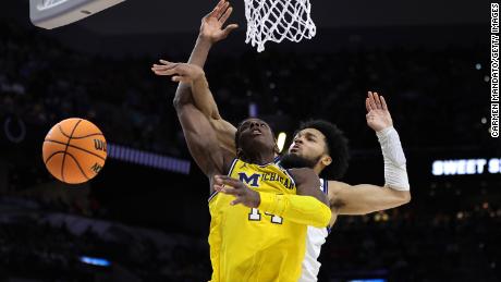 Caleb Daniels of the Villanova Wildcats blocks a shot by Moussa Diabate of the Michigan Wolverines during the second half of their Sweet 16 game in 2022.