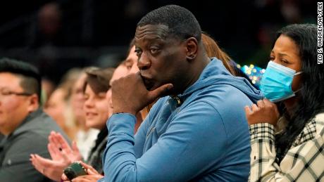 Former Seattle SuperSonics forward Shawn Kemp, center, attends a WNBA basketball game between the Seattle Storm and the Chicago Sky on May 18, 2022, in Seattle.