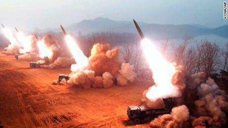 North Korea fires at least six short-range missiles as Kim Jong Un and daughter look on 