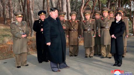 In this photo provided by the North Korean government, North Korean leader Kim Jong Un, with his daughter, provides guidance to military officials at an undisclosed location in North Korea, Thursday, March 9, 2023. 