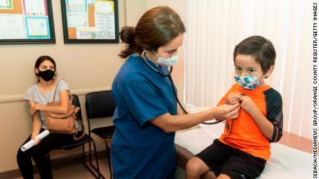 Ladera Ranch, CA - July 28: Dr. Kate Williamson lets a child listen to his heart during a yearly routine exam as his mom watches at Southern Orange County Pediatric Associates in Ladera Ranch, CA on Tuesday, July 28, 2020. Kids and teens 17 and under make up far less than their share of COVID-19 cases in relation to their proportion of Orange Countys overall population. Testing rates could also be a factor in the lower numbers as kids dont show symptoms like older people do.
