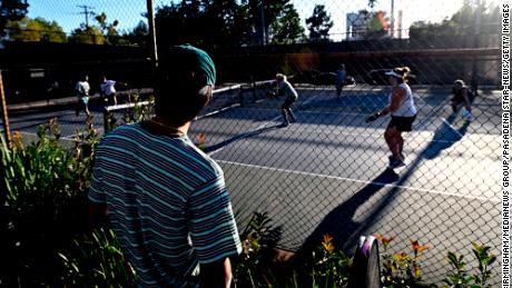 People play pickleball on what were once tennis courts at Allendale Park in Pasadena, CA, in 2022. 
