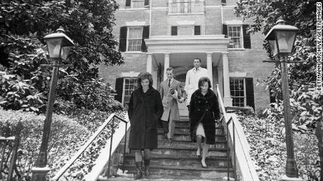 Jacqueline Kennedy, left, and her sister Lee Radziwill, right, are seen leaving the new Georgetown home.