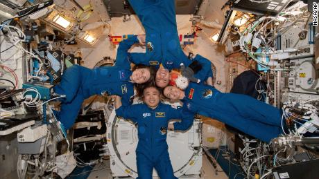 In this photo made available by NASA, clockwise from left, Expedition 68 Flight Engineers Anna Kikina of Roscosmos, Josh Cassada and Nicole Mann from NASA, and Koichi Wakata of JAXA (Japan Aerospace Exploration Agency) gather for a portrait inside the International Space Station&#39;s Kibo laboratory module on March 1, 2023.