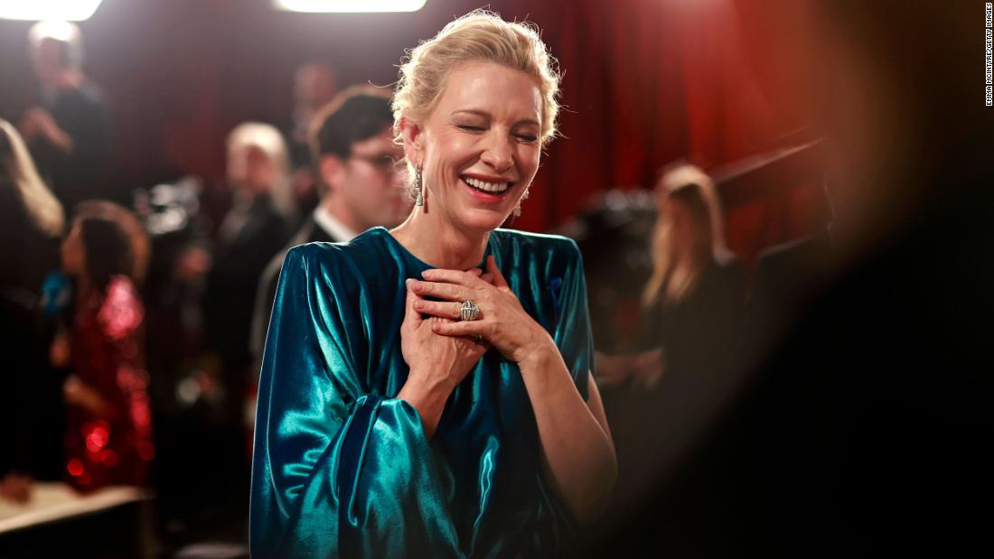 Cate Blanchett laughs while walking the red carpet.