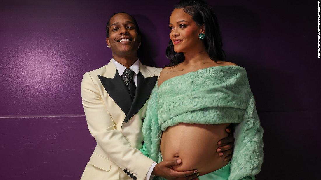 A Rocky puts his hand on Rihanna&#39;s belly backstage. The two are expecting their second child together.