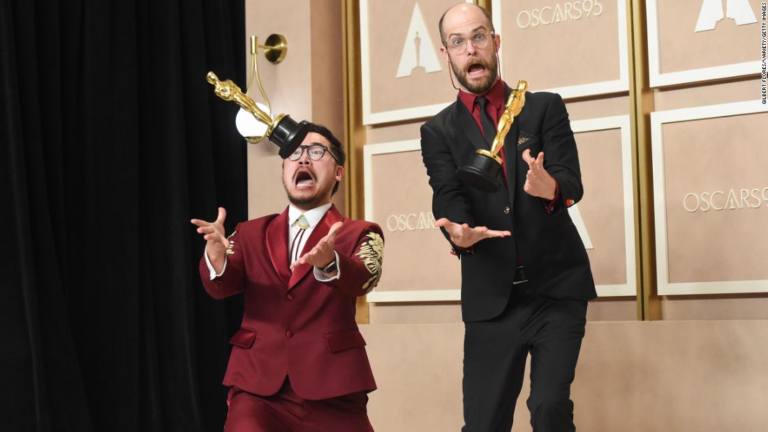 Kwan, left, and Scheinert have fun with some of their Oscars as they meet with the press.