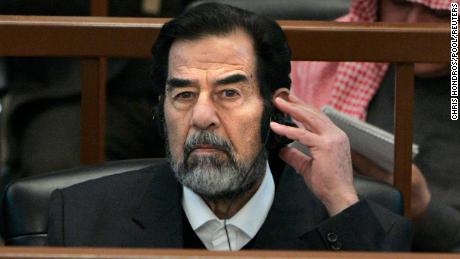 Ousted Iraqi leader Saddam Hussein listens to a translation through a headset during his 2006 trial.