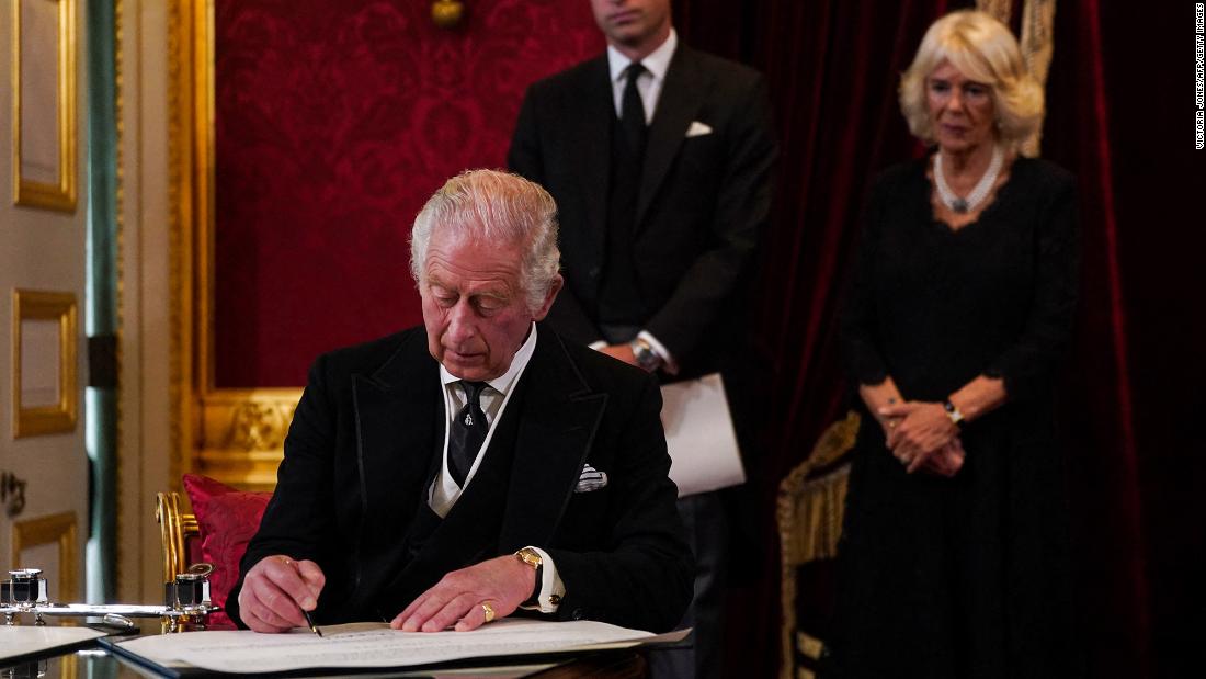 Charles signs an oath to uphold the security of the Church in Scotland during a meeting of the Accession Council in London that proclaimed him as the new King.