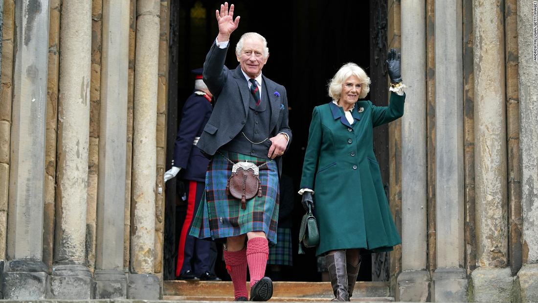 Charles and Camilla wave as they leave Dunfermline Abbey in Scotland during a visit in October 2022.