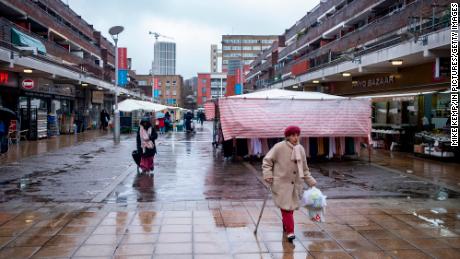 People pictured in the market area on Watney Street in Shadwell, London on March 8, 2023.