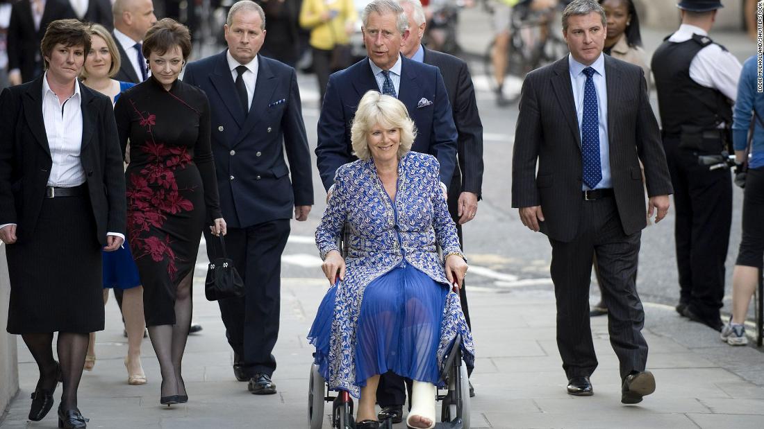 Charles pushes Camilla in a wheelchair as they attend the premiere of &quot;Aida&quot; at the Royal Opera House in London in April 2010. She had suffered a broken leg weeks prior.