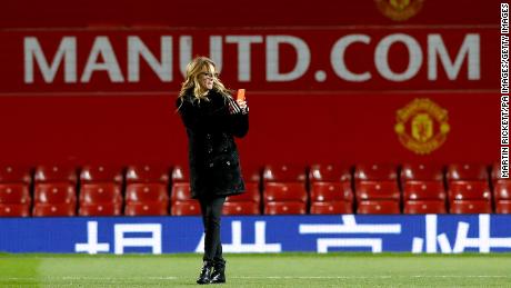 Julia Roberts takes photographs on the pitch after Manchester United&#39;s Premier League match at Old Trafford against West Ham. 