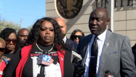 Tiffany Carter stands by attorney Ben Crump at a news conference on Tuesday, March 14.