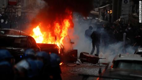 A car is seen on fire during clashes between Eintracht Frankfurt fans and Italian police ahead of the Champions League match between Napoli and Frankfurt in Naples.