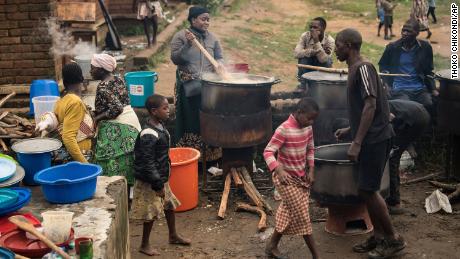 Community volunteers prepare meals for people who were displaced following heavy rains by tropical Cyclone Freddy in Blantyre, southern Malawi, Thursday, March 16, 2023. 