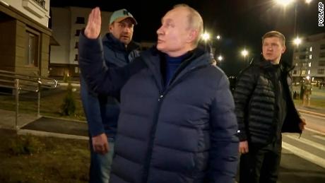 Putin waves to local residents after visiting their new flat during his visit to Mariupol in Russian-controlled Donetsk region, Ukraine.