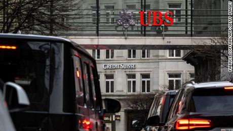 A sign of Credit Suisse bank is seen behind a sign of Swiss banking UBS, in Zurich on March 18, 2023. Switzerland&#39;s largest bank, UBS, is in talks to buy all or part of Credit Suisse, according to a report by the Financial Times. Credit Suisse -- Switzerland&#39;s second-biggest bank -- came under pressure this week as the failure of two US regional lenders rocked the sector. 