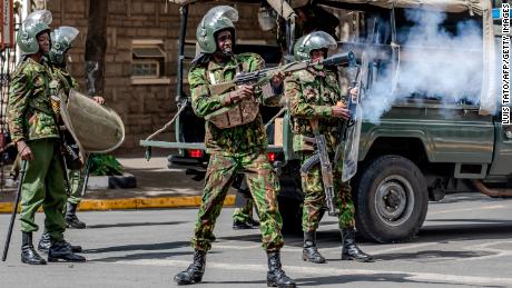 A Kenyan police officer fires tear gas at protesters in Nairobi, Kenya, on Monday.