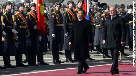 Chinese leader Xi Jinping, accompanied by Russian Deputy Prime Minister Dmitry Chernyshenko, walks past honour guards during a welcoming ceremony at Moscow&#39;s Vnukovo airport on March 20, 2023. 