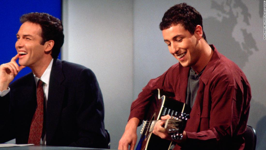 Sandler, next to Norm Macdonald, plays &quot;The Chanukah Song&quot; during an &quot;SNL&quot; episode in 1994. The comedic song, which talks about Hanukkah and famous people who are (and are not) Jewish, would later go on to be released as a single. It was certified gold.