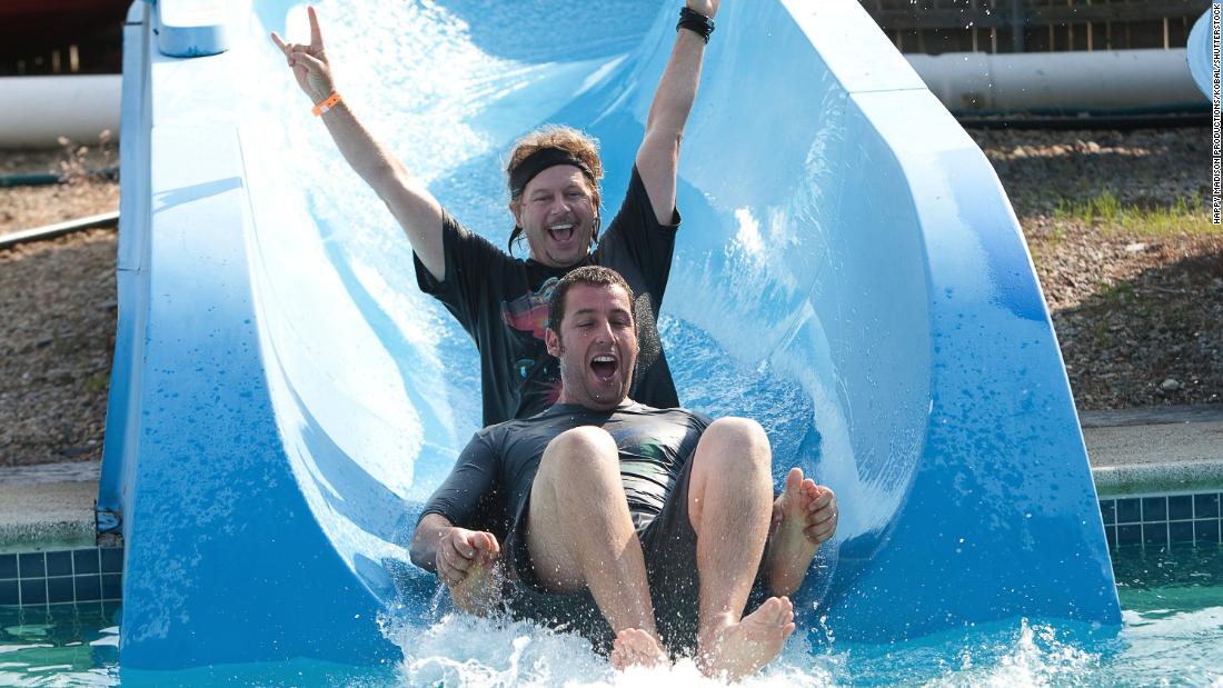 Sandler and Spade go down a water slide in the 2010 comedy &quot;Grown Ups.&quot;