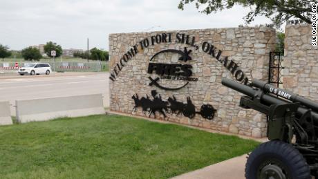 A vehicle drives by a sign at Scott Gate, one of the entrances to Fort Sill, in Fort Sill, Oklahoma.