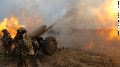 Ukrainian troops fire a D-30 howitzer at Russian positions near Bakhmut, where heavy fighting has taken place for weeks.