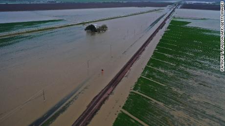 An aerial image shows flooded roads and Central Valley farmland Tuesday near Corcoran, California.